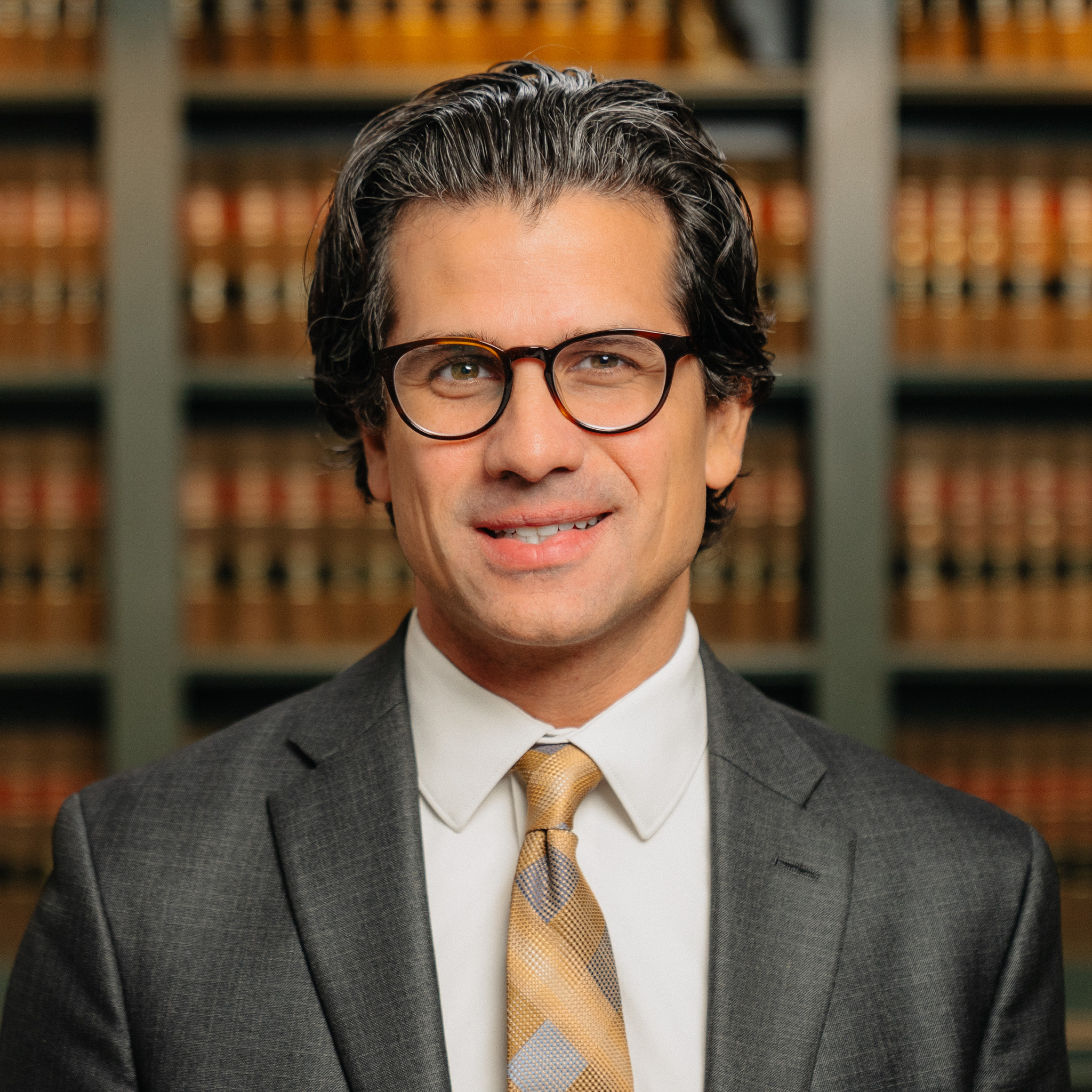 headshot of attorney Joseph Engerer in Northville, MI in front of a shelf of books
