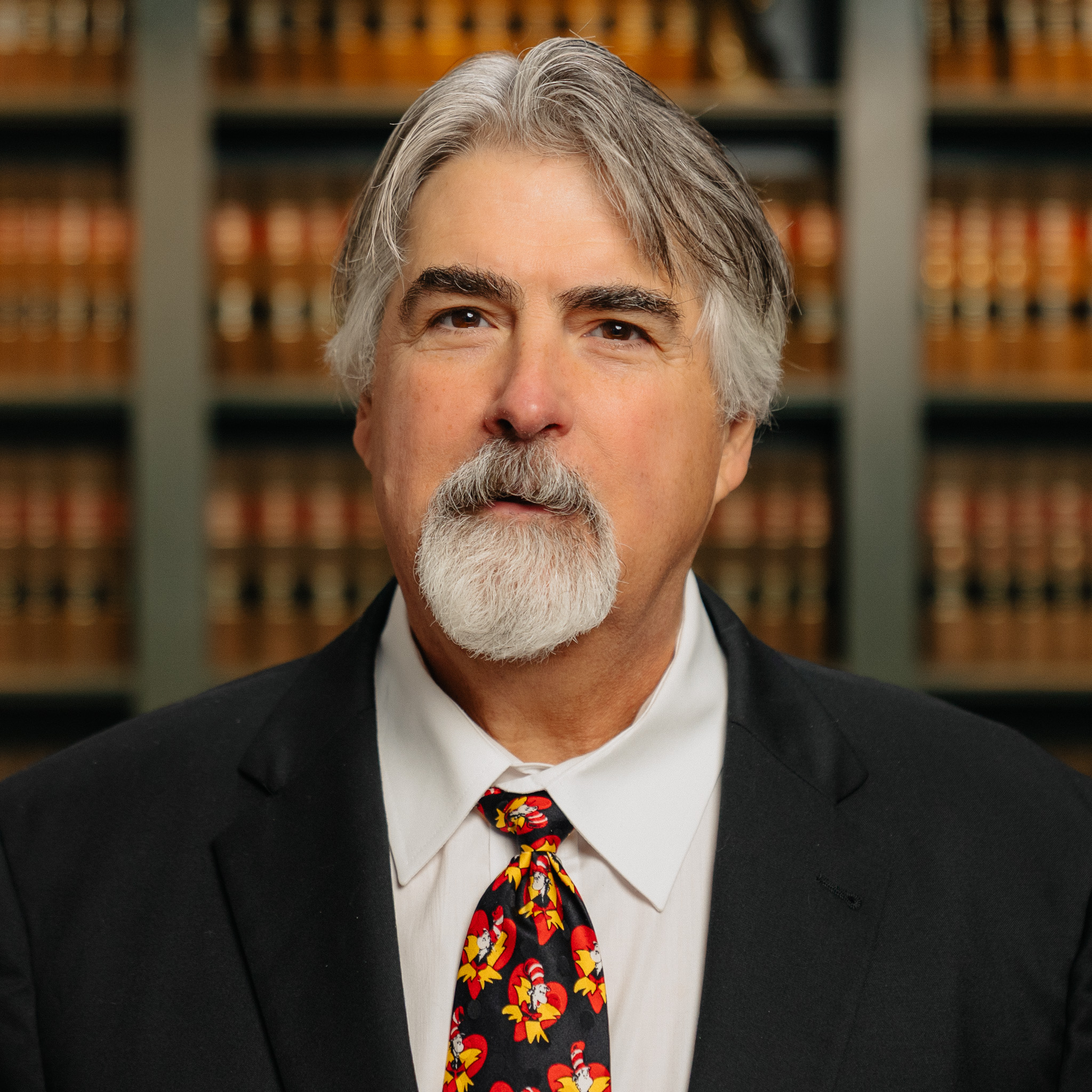 headshot of attorney Mark Ellis in Northville, MI in front of a shelf of books